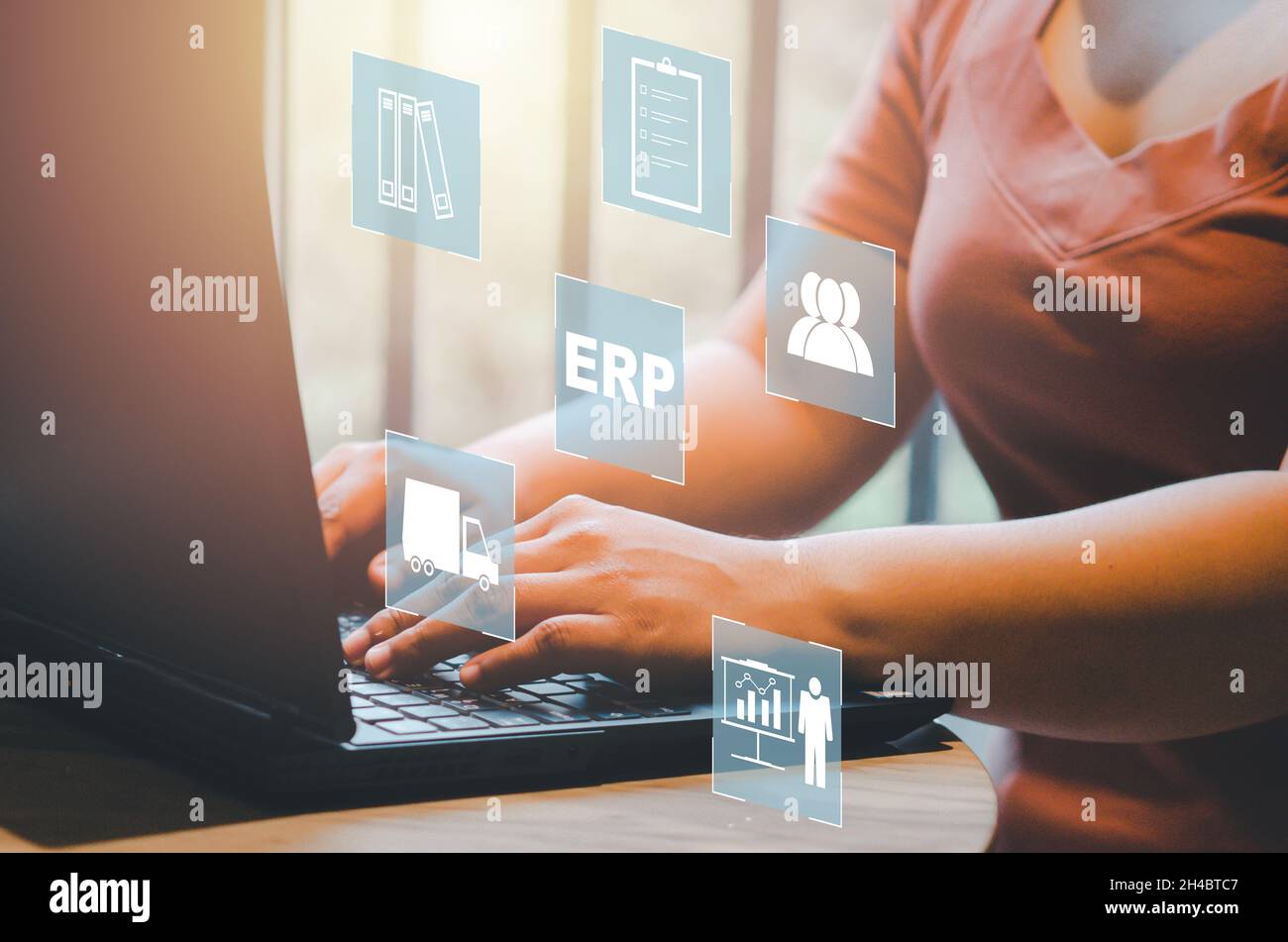 Enterprise Resource Planning (ERP) document management concept icons on virtual screen.hands typing on computer laptop as background Stock Photo
