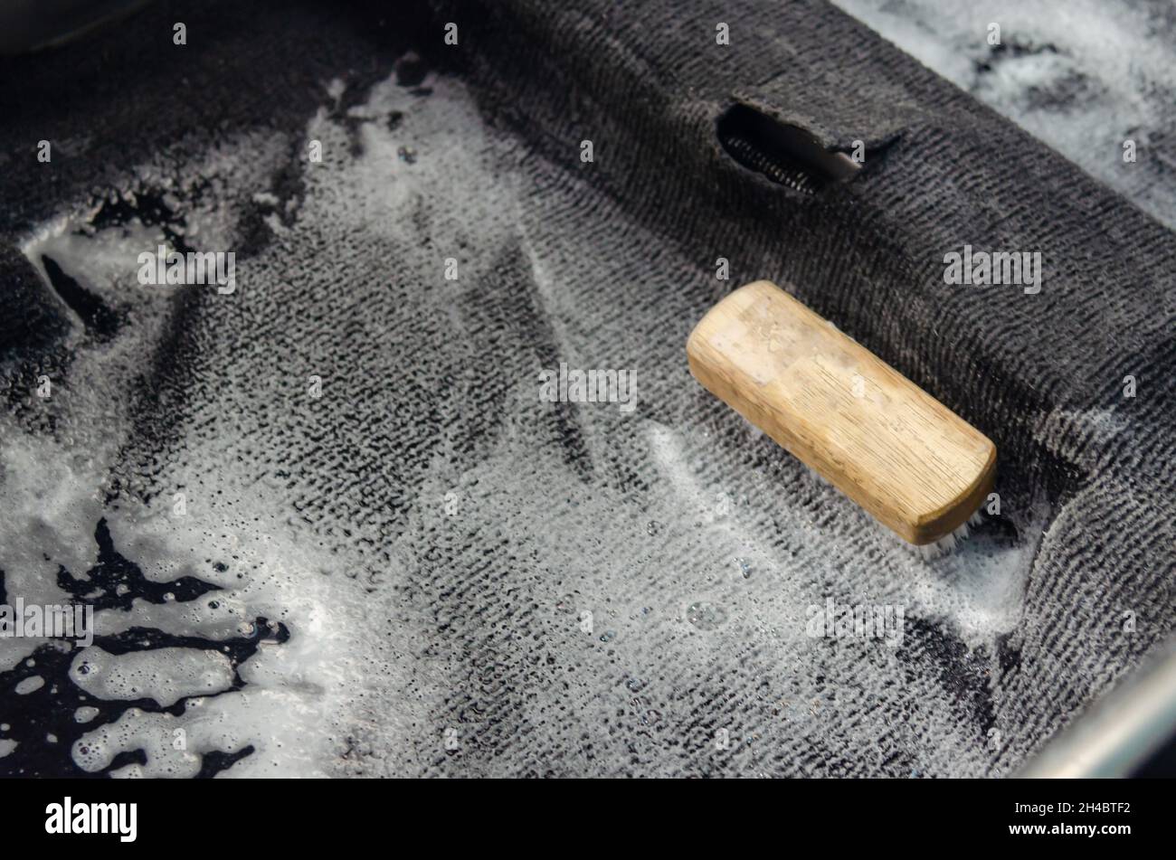 Wash the car carpet.Detailing on interior of modern car.Clean by using