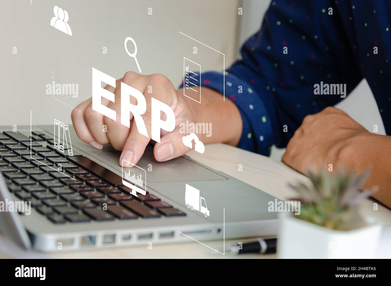 Enterprise Resource Planning (ERP) Software system for business resource plans. concept hand typing computer laptop icons on virtual screen. Stock Photo
