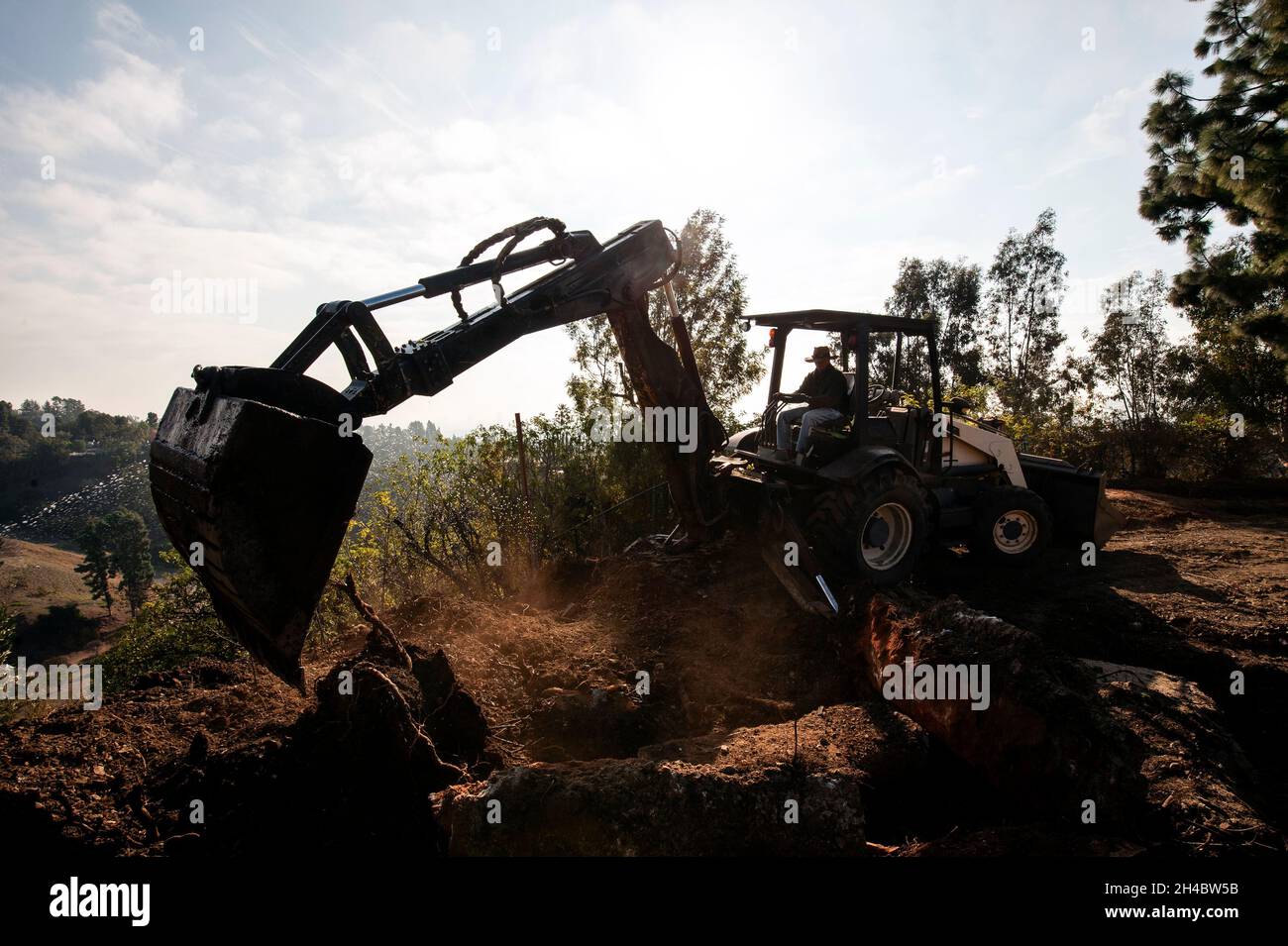 Backhoe excavating for a new construction project Stock Photo Alamy