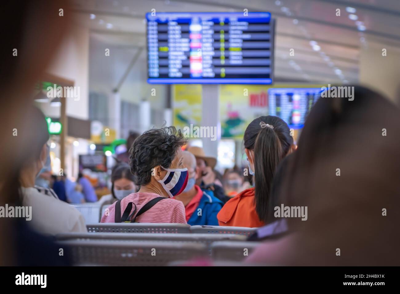 Travellers wear mask at airport to prevent infection from COVID-19. People in protective mask at public place. Vietnam, Nha Trang: 2021-05-04 Stock Photo