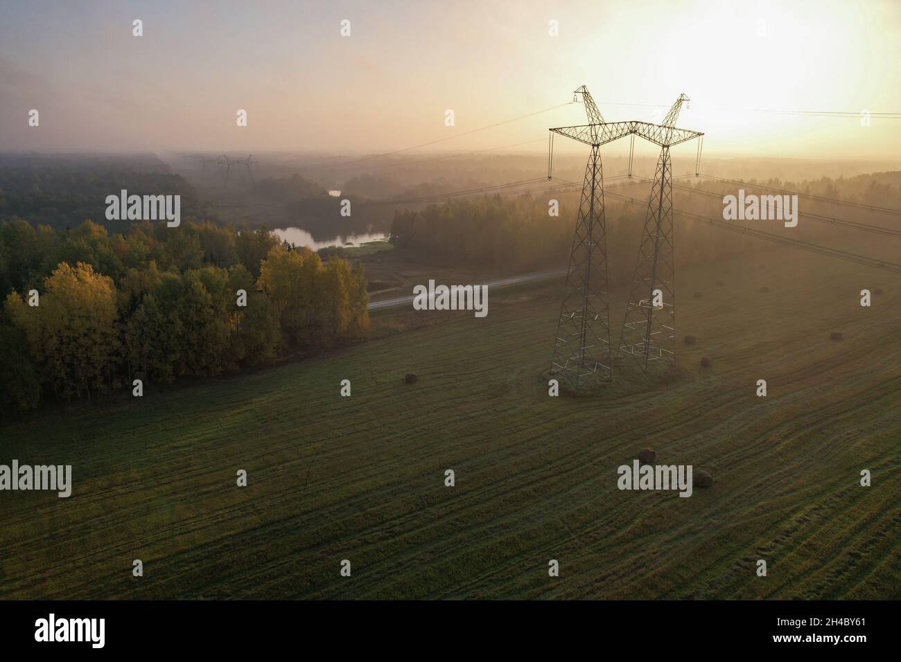 Support of a high-voltage power line in a wooded rural area. Stock Photo
