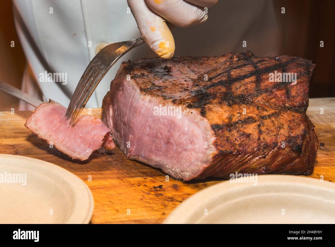 Beef is served at a carving station at a dinner buffet at an event