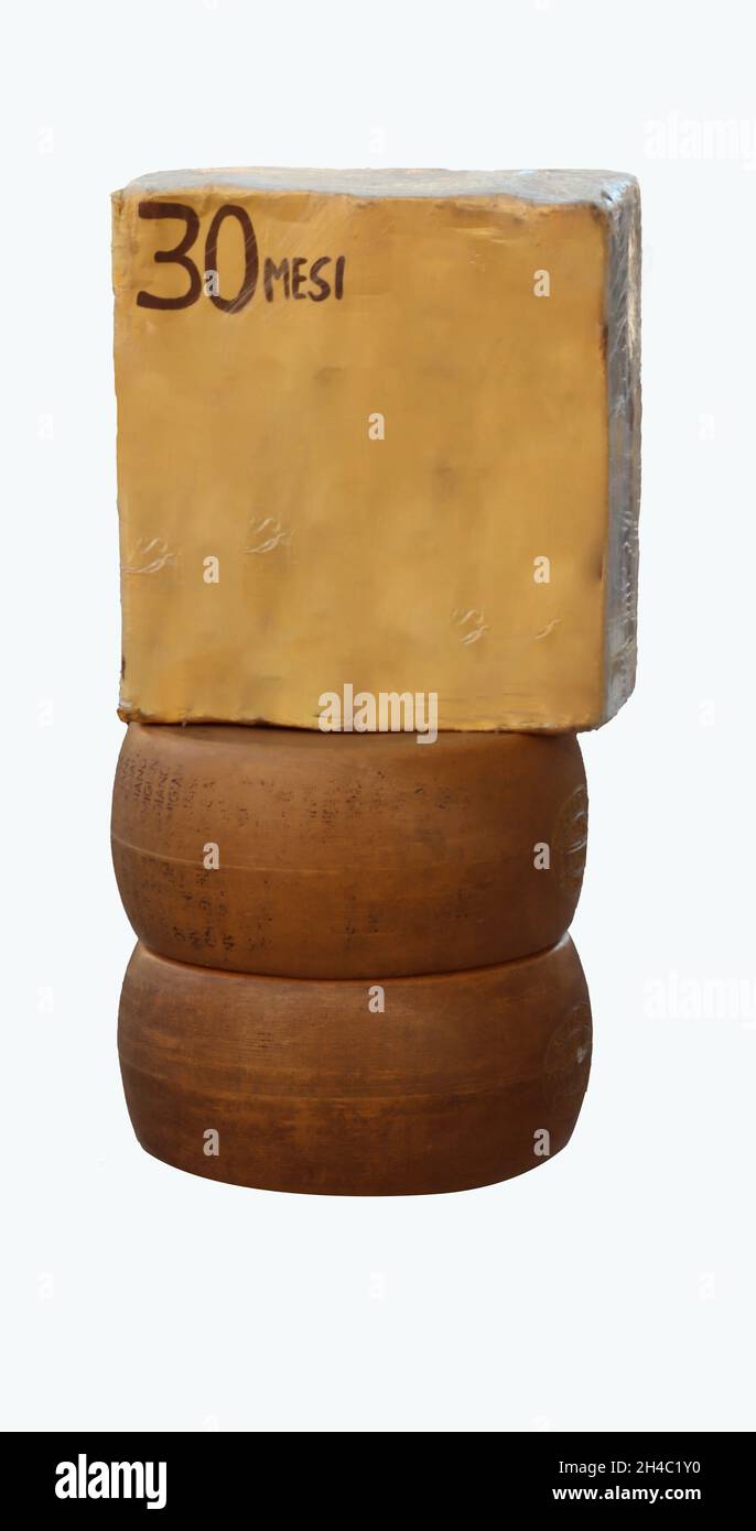 Vertical shot of three 30 month aged parmesan cheeses with a white background Stock Photo