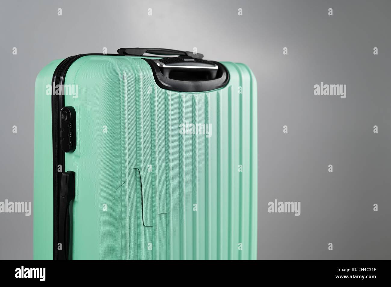 Close-up of a broken suitcase on a white background. Damaged