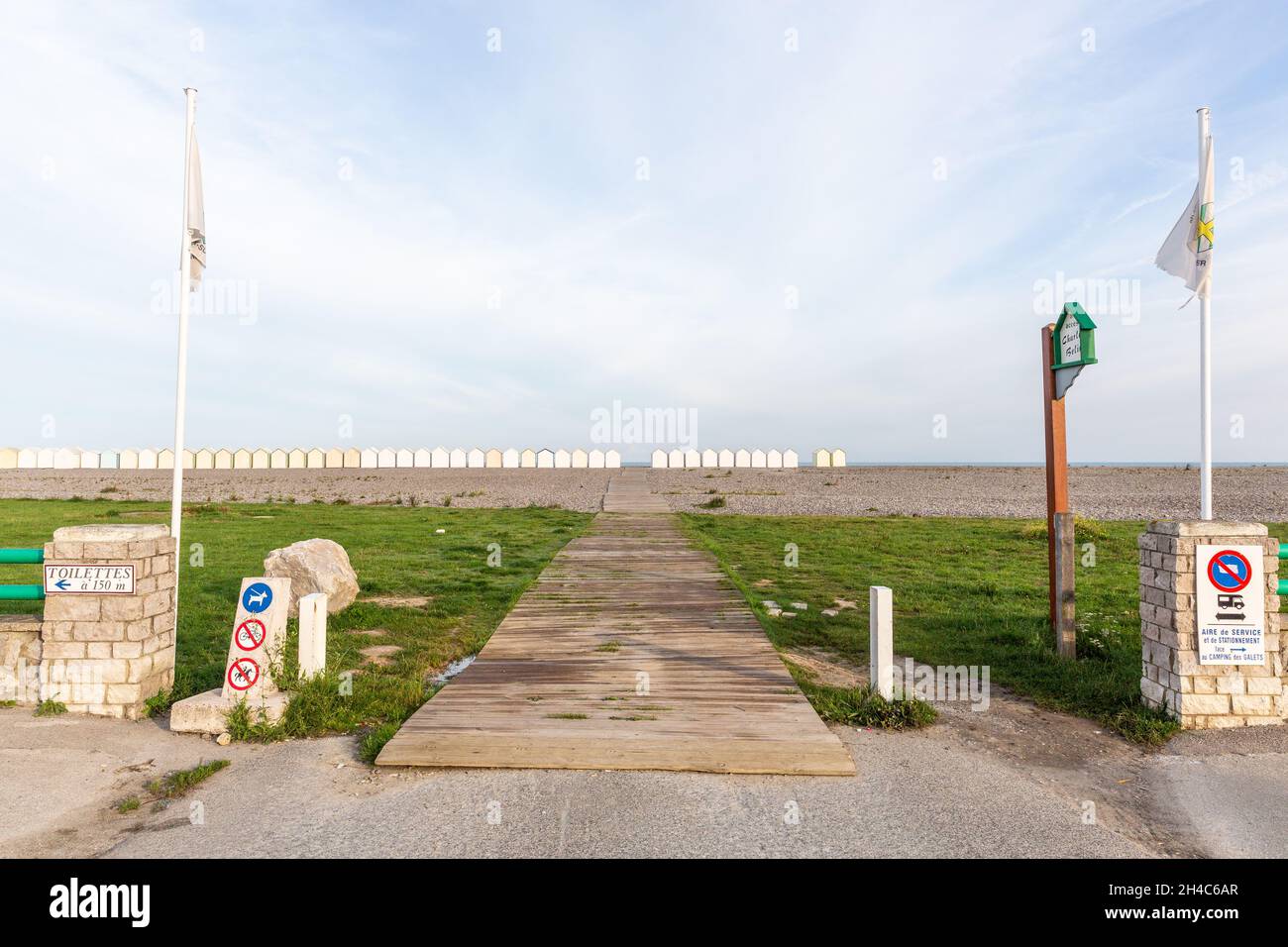 Gateway to the sea, on a pebble beach. Line of beach huts on the horizon. Cayeux-sur-Mer, Opal Coast, France Stock Photo