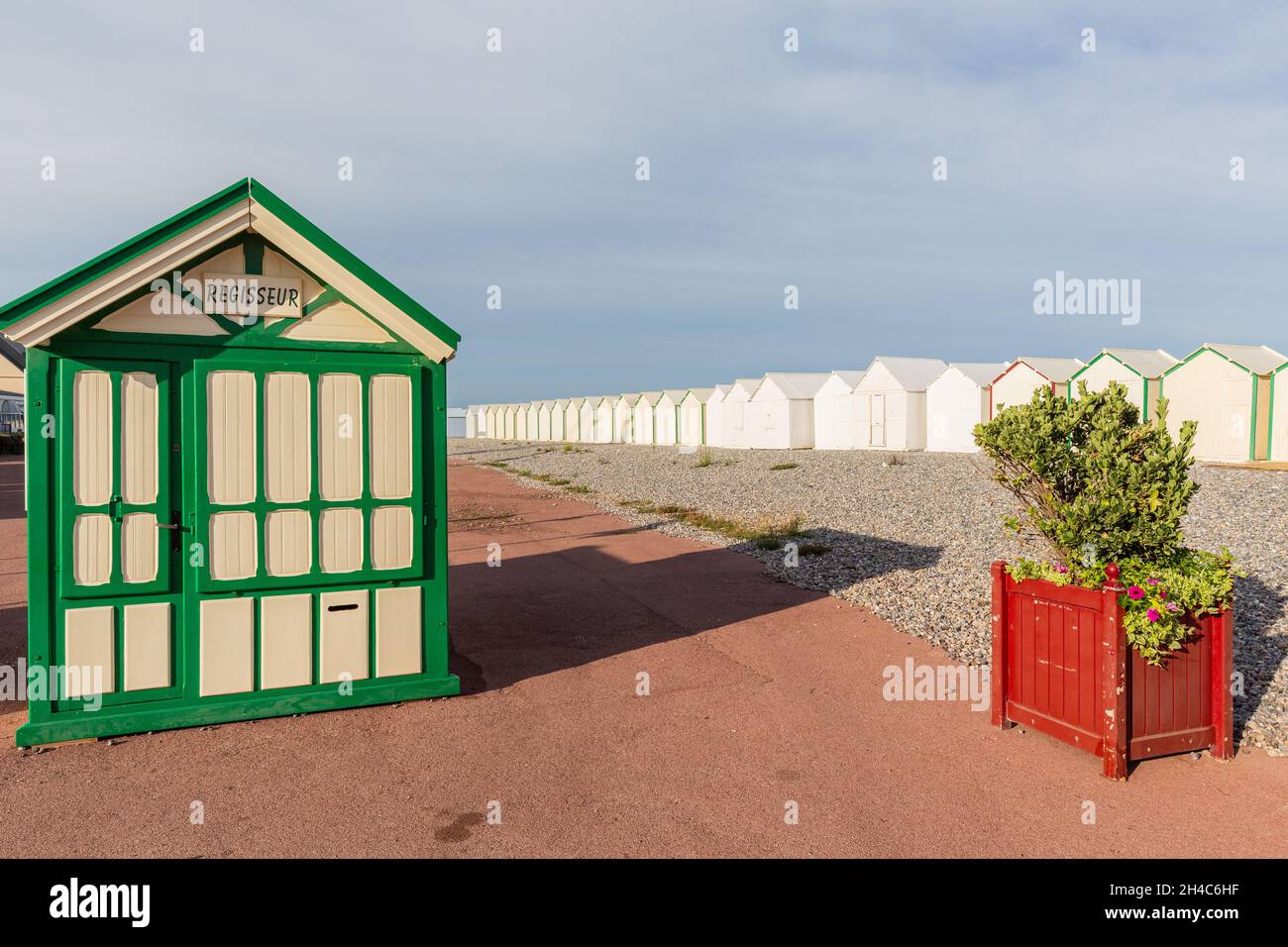 White and green beach cabin serving as a rental office. Cabins lined up on the horizon. Cayeux-sur-Mer. Opal Coast, France Stock Photo