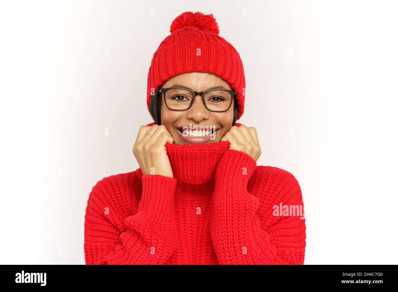 Funny woman wearing warm knitted hat and sweater. African american woman dressed winter in clothes Stock Photo