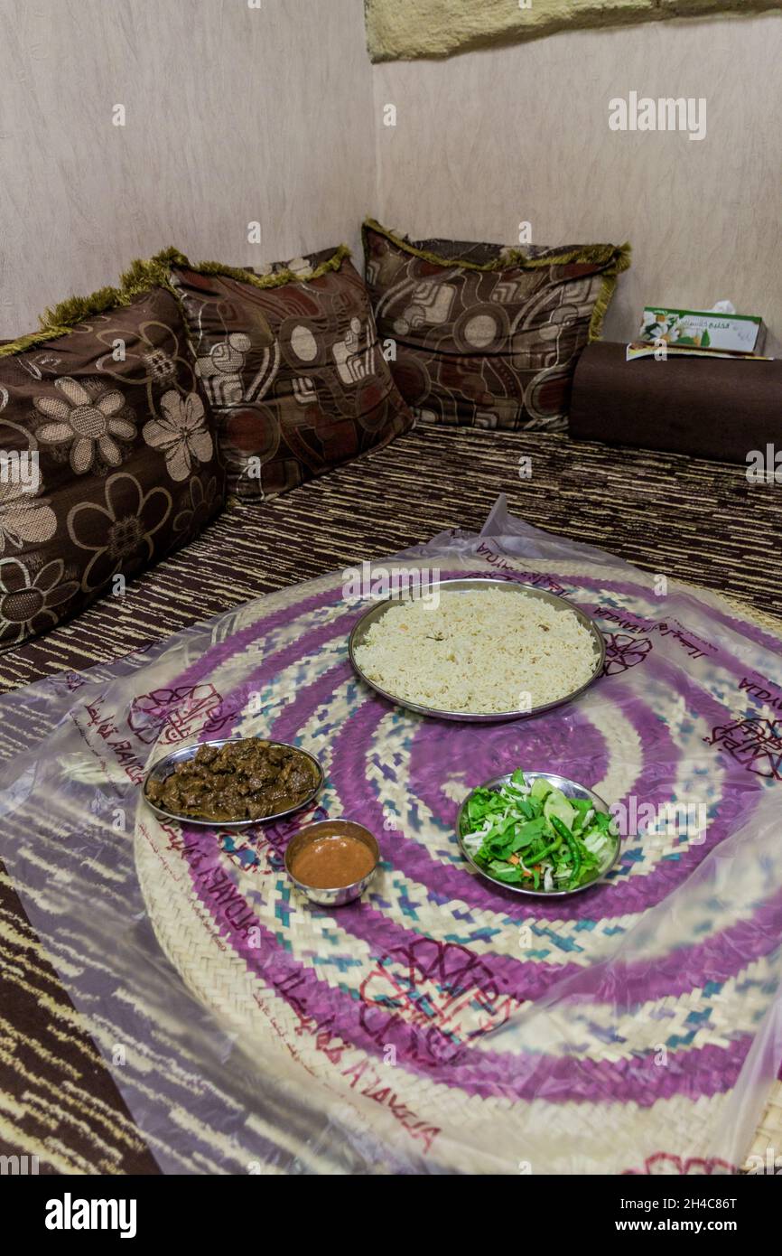 MUSCAT, OMAN - FEBRUARY 21, 2017: Traditional food eaten on ground in a restaurant in Muscat, Oman Stock Photo