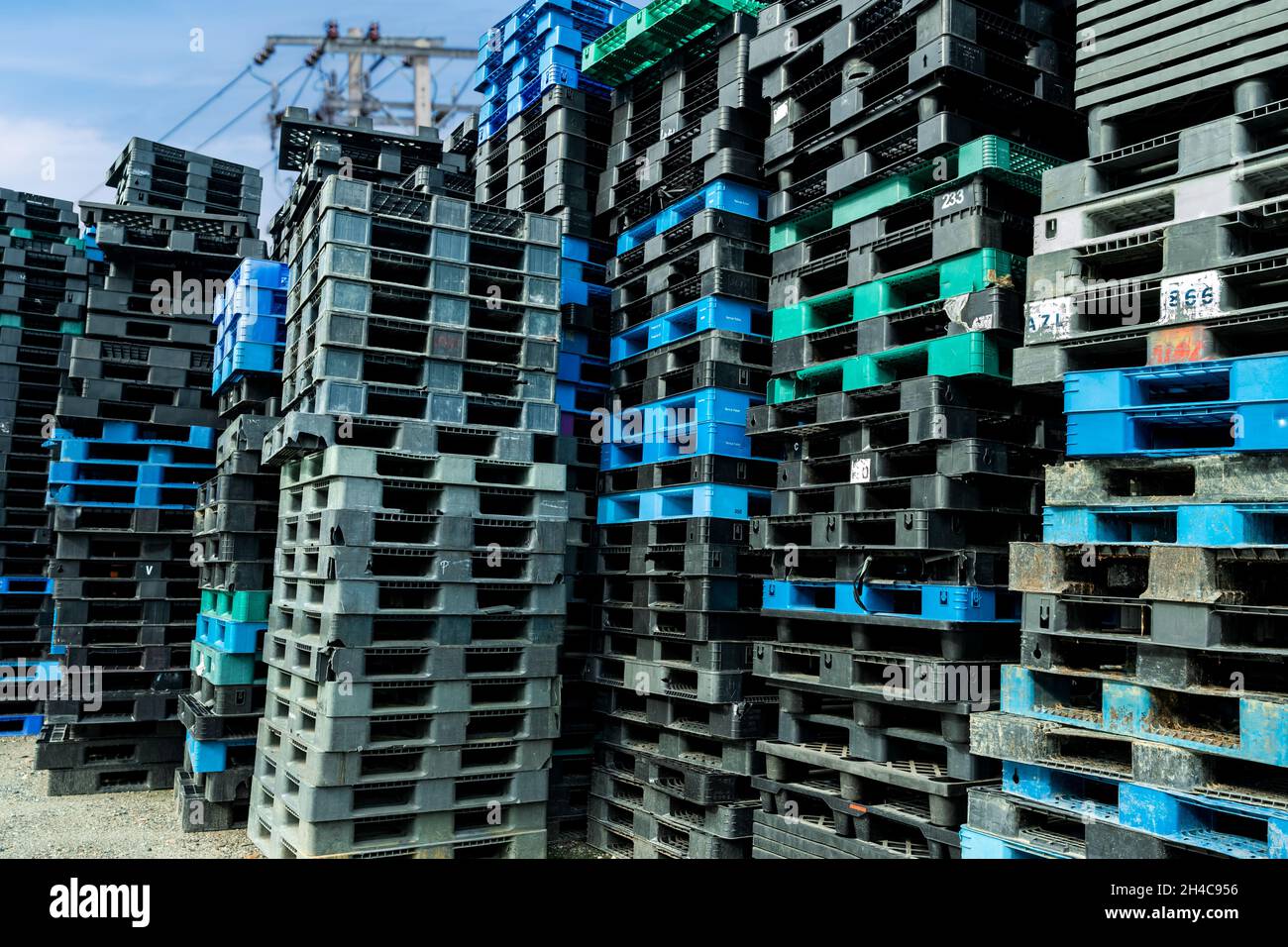 Pile of plastic shipping pallet. Industrial plastic pallet stacked at factory warehouse. Cargo
