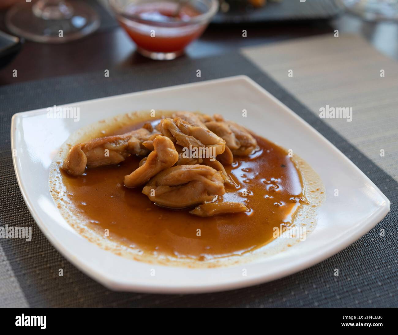 Asian dish with chicken and Teriyaki sauce at the restaurant Stock Photo