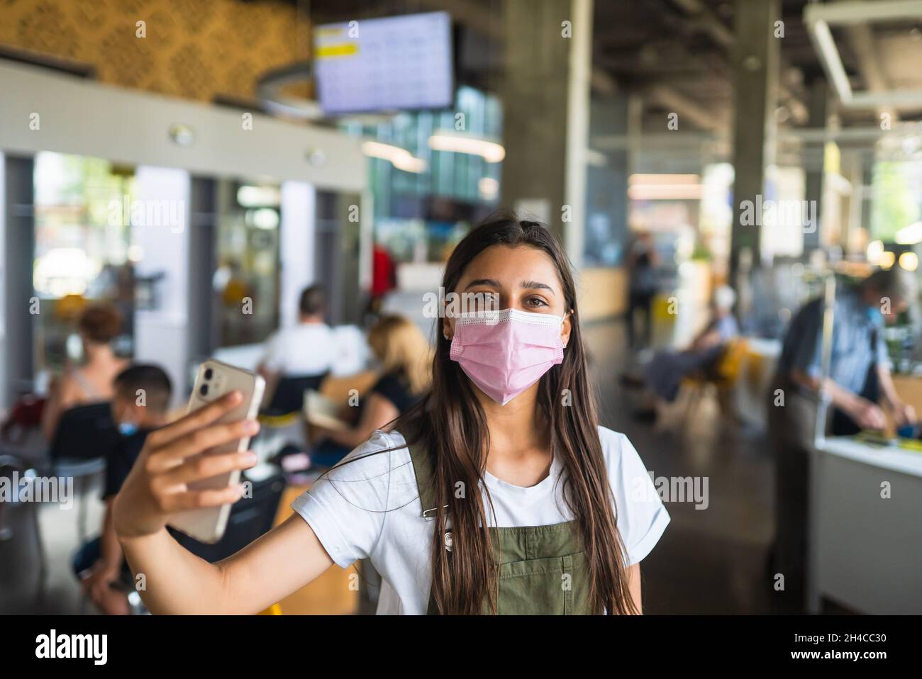 Young woman wearing mask uses hi-res stock photography and images - Alamy