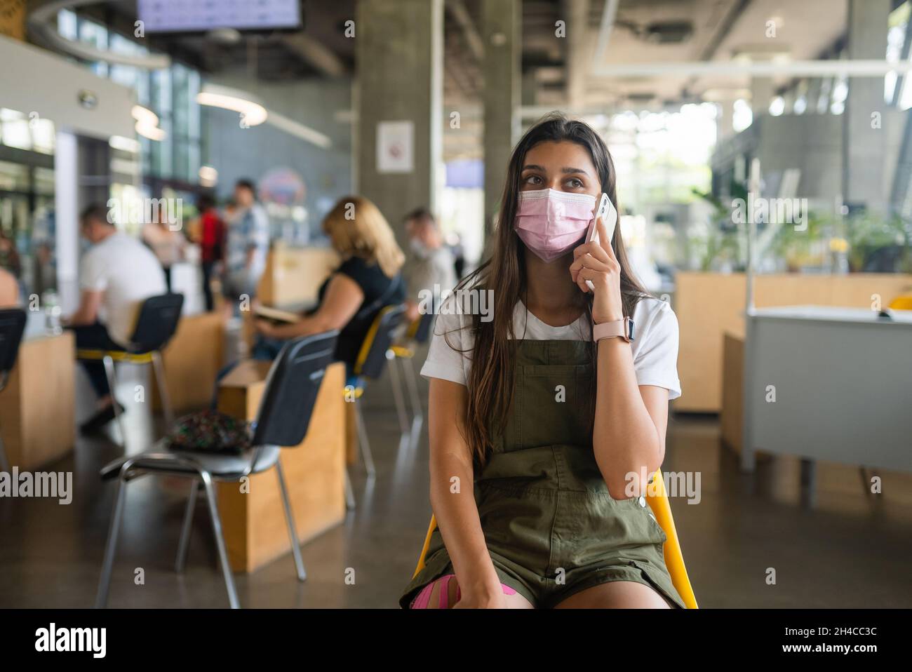 Young woman wearing mask uses hi-res stock photography and images - Alamy