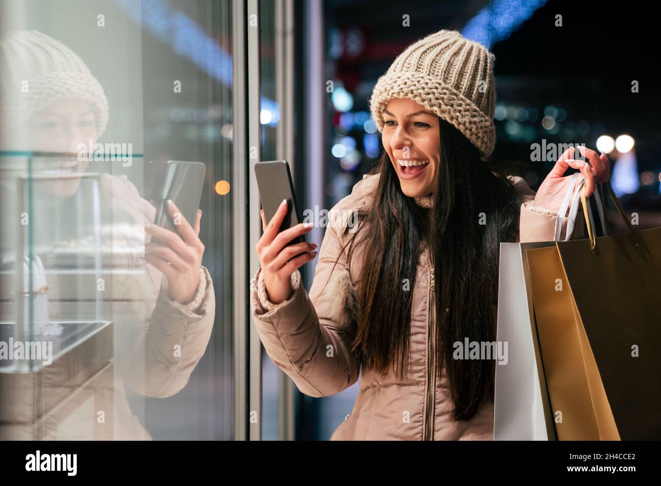 Happy woman with shopping bags enjoying in shopping. Consumerism, shopping, lifestyle concept Stock Photo