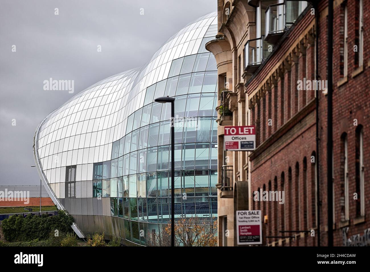 Newcastle upon Tyne Quayside area framed by the Sage Gateshead waterfront concert venue Stock Photo