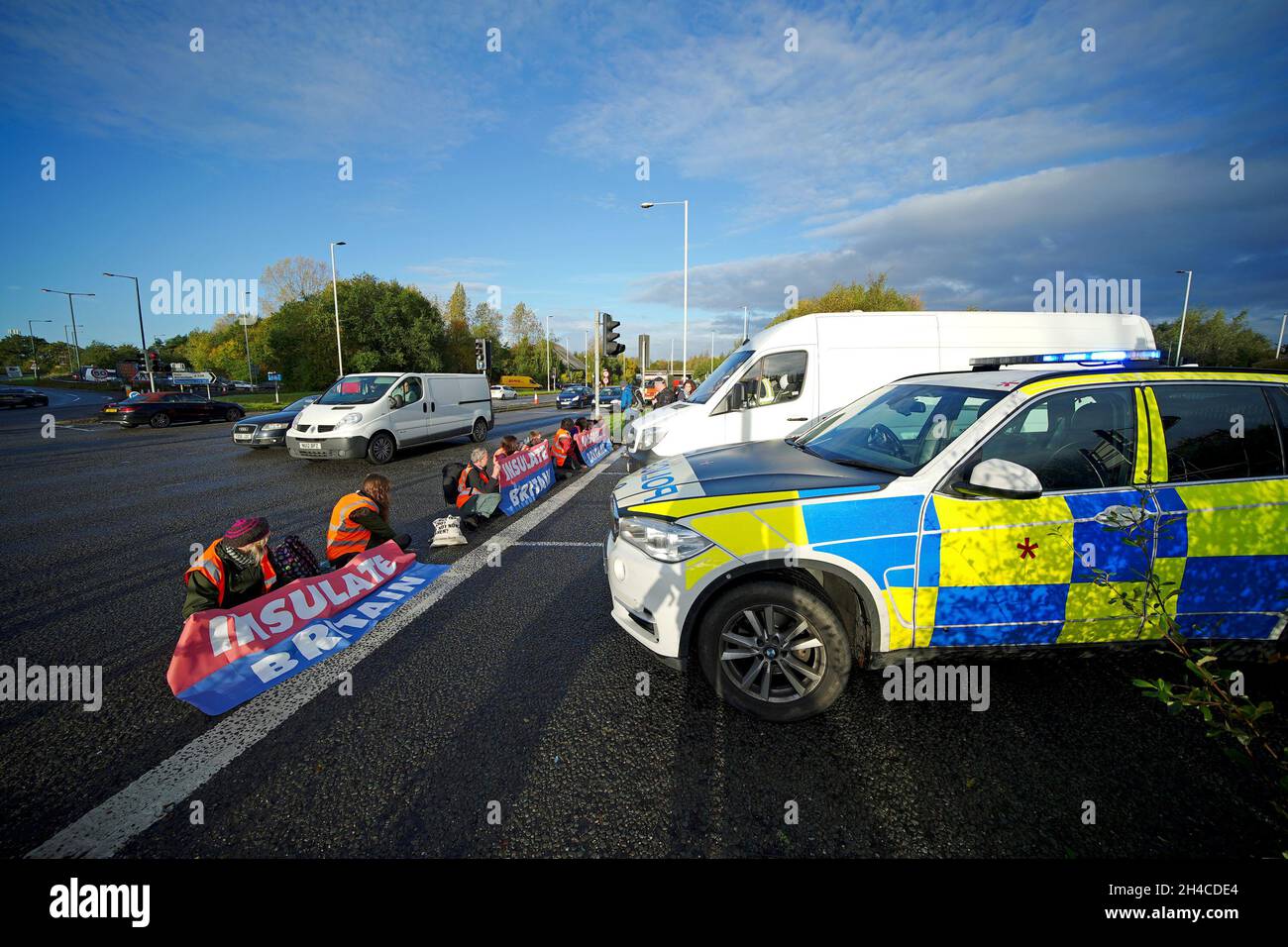 Protesters from Insulate Britain blocking a road near to the Holiday Inn Express Motorway Airport in Manchester. Picture date: Tuesday November 2, 2021. Stock Photo