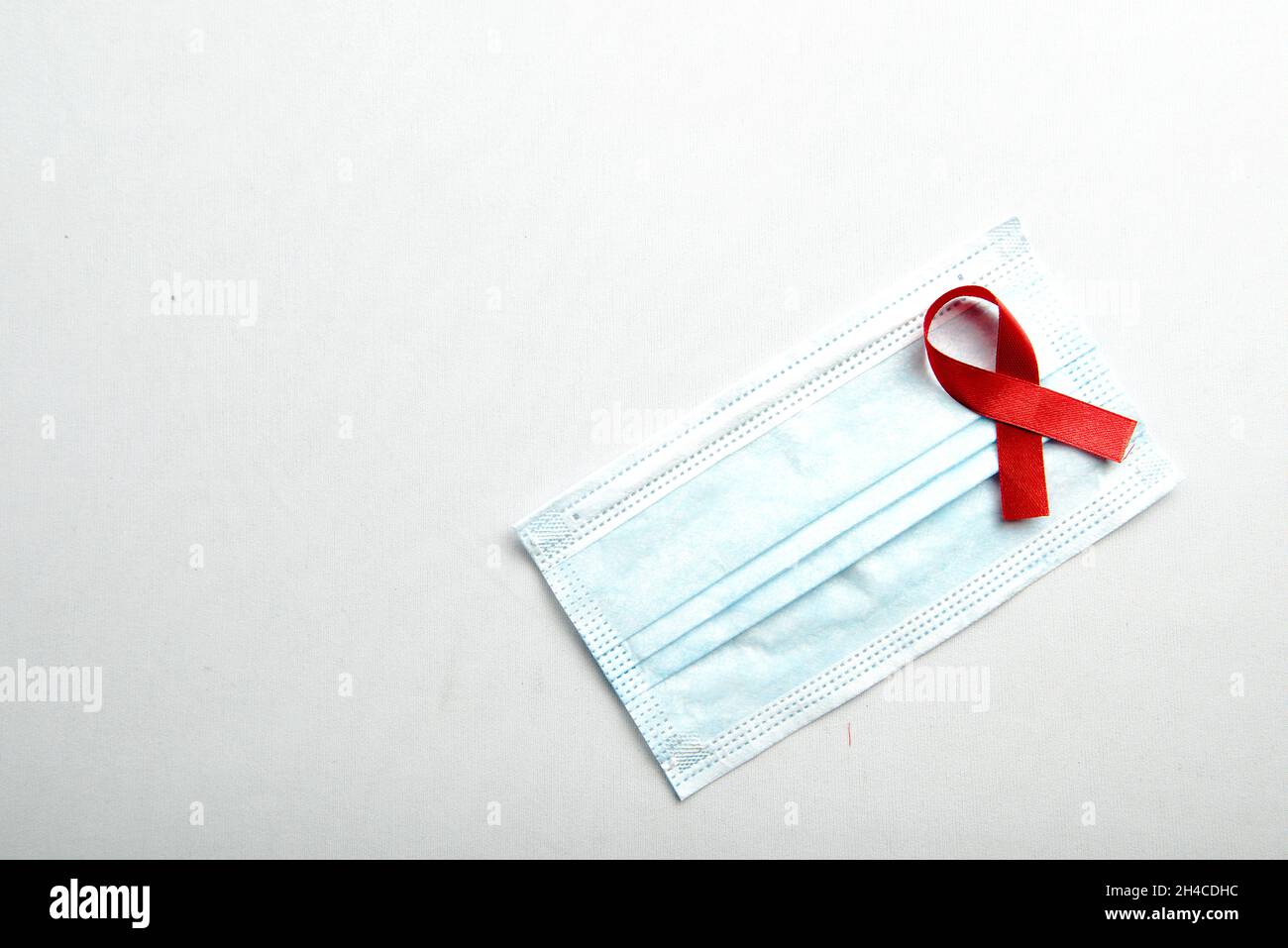Red ribbon and face mask with white background. Hiv Aids ribbon ...