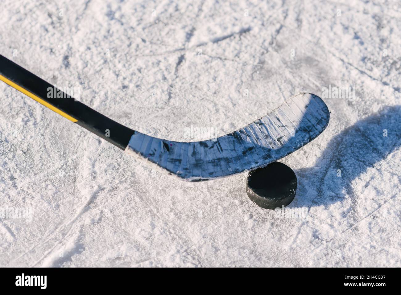 Close-up of an ice hockey stick with a hockey puck Stock Photo - Alamy