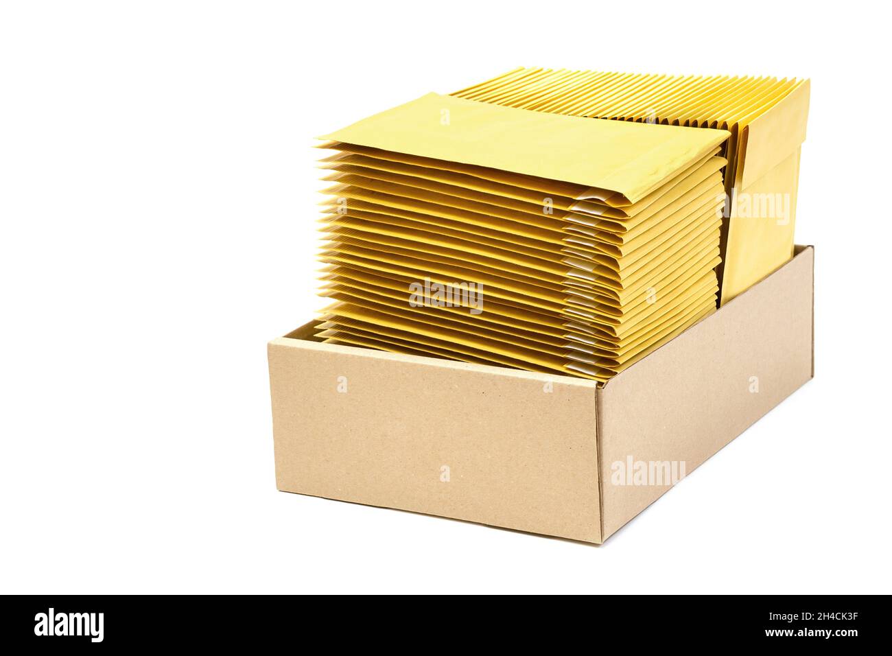 Two stacks of jiffy bags in a kraft cardboard box isolated on white