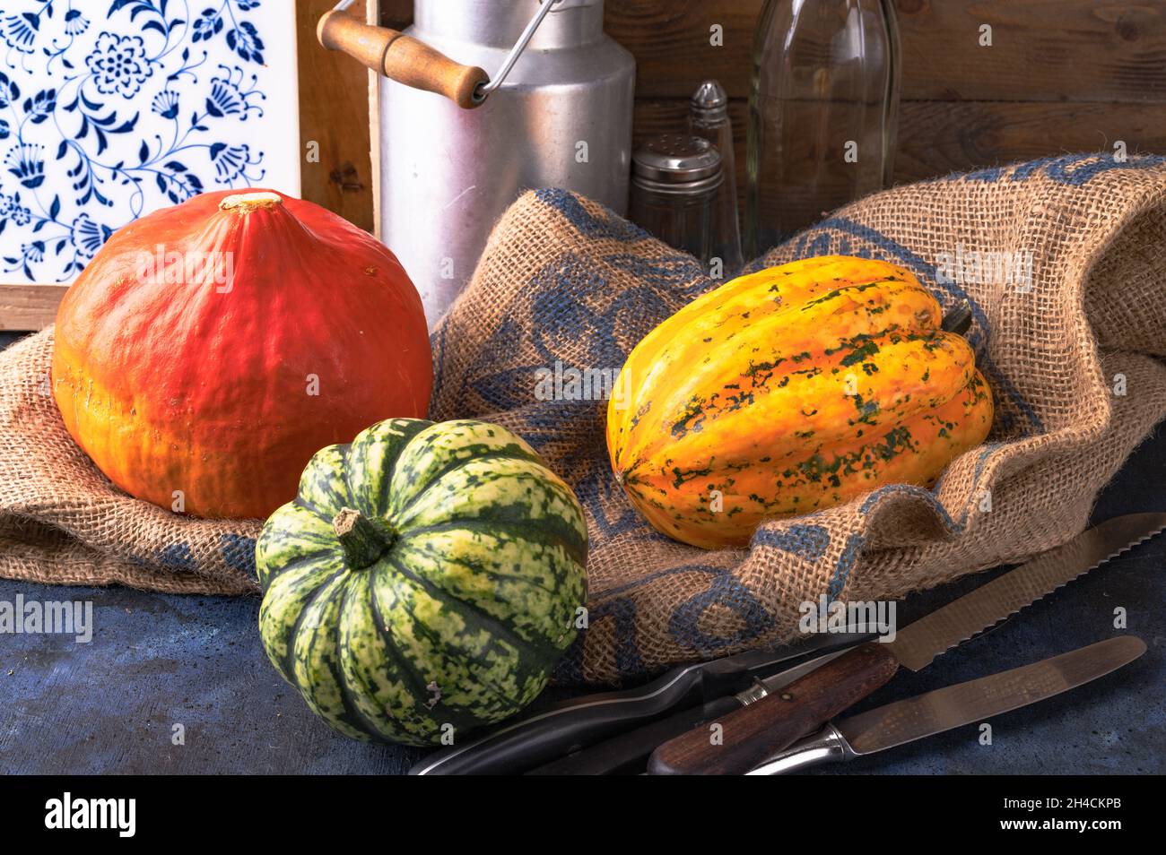 Pumpkins lying on a straw sack in a wooden box Stock Photo - Alamy