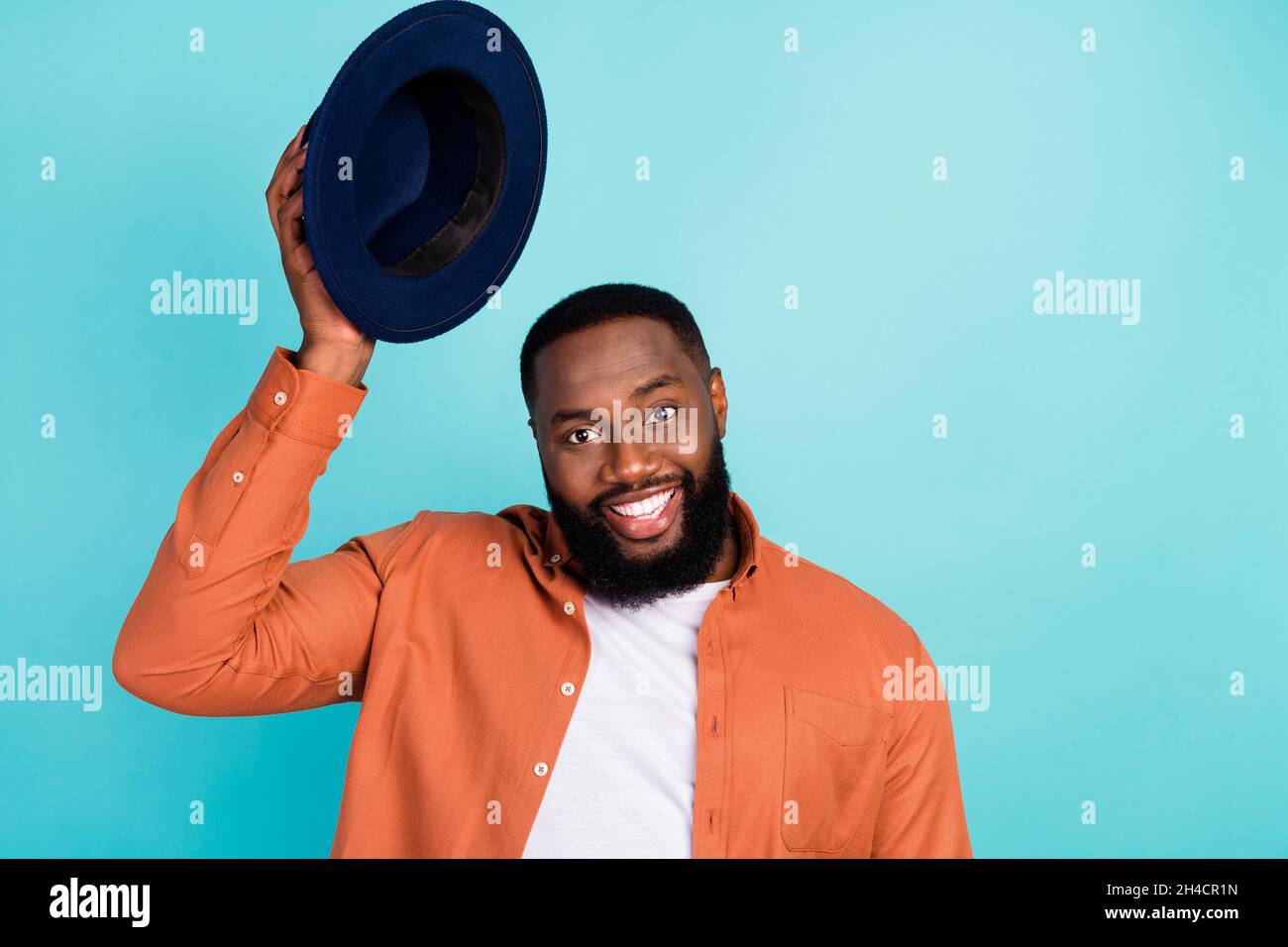 Photo of young african man happy positive smile gentleman hold headwear ...