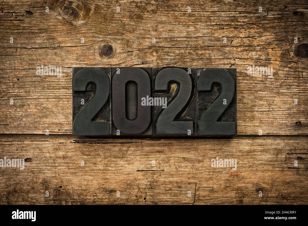 Year 2022 written with vintage letterpress printing blocks on rustic wooden background Stock Photo