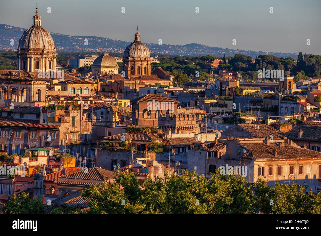 Sunset in city of Rome in Italy. Cityscape with traditional hillside houses and church domes. Stock Photo