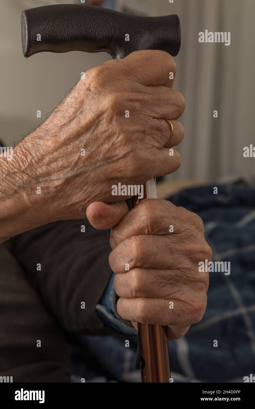 Senior Hands. Extreme Close. Retired grandpa holding his walking stick. Stock image. Stock Photo