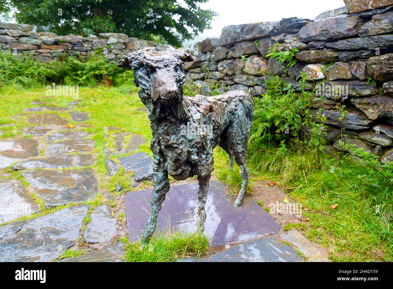 Bronze sculpture of the dog Gelert, placed in a ruined cottage near Gelert's Grave, Beddgelert, Snowdonia National Park, Gwynedd, Wales, UK Stock Photo