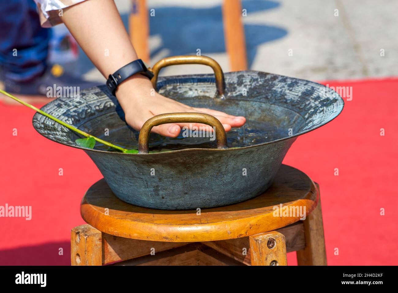 People wash their hands in the bronze basin at the ceremony to worship Confucius Stock Photo
