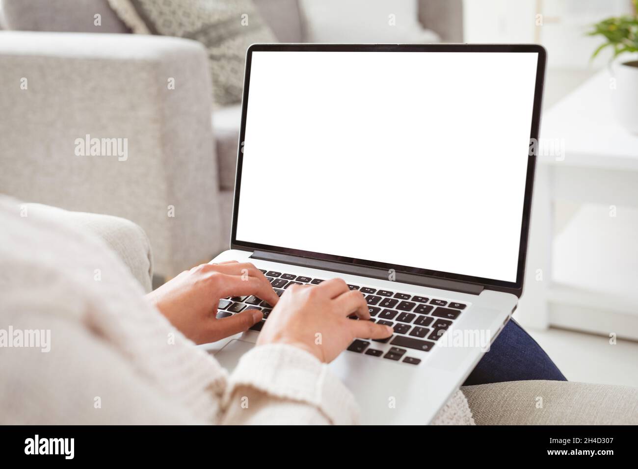 Hands of woman working remotely from home on laptop with copy space Stock Photo