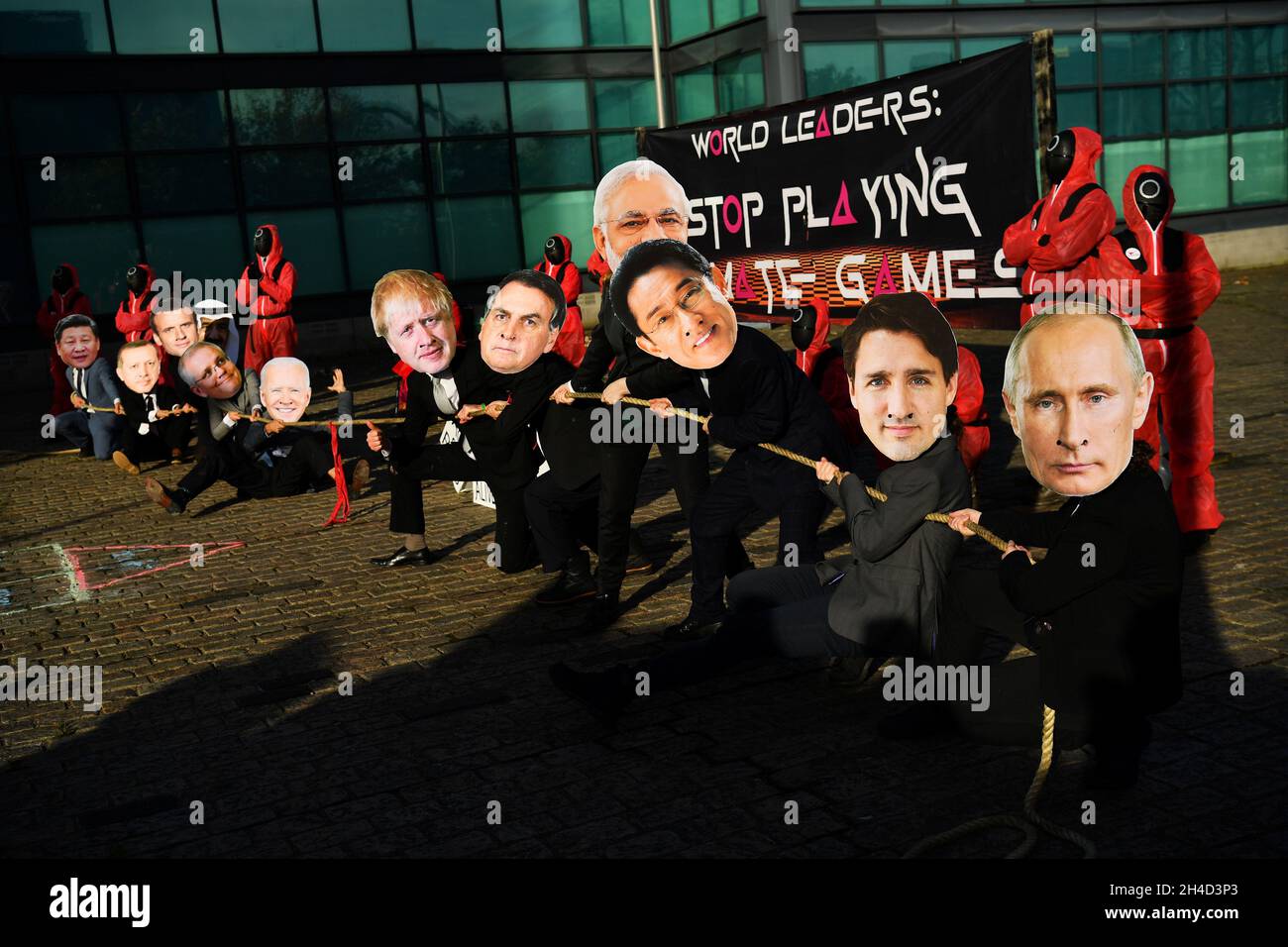 Climate activists dressed as world leaders take part in a 'Squid Games' inspired protest during the UN Climate Change Conference (COP26) in Glasgow, Scotland, Britain November 2, 2021. REUTERS/Dylan Martinez Stock Photo