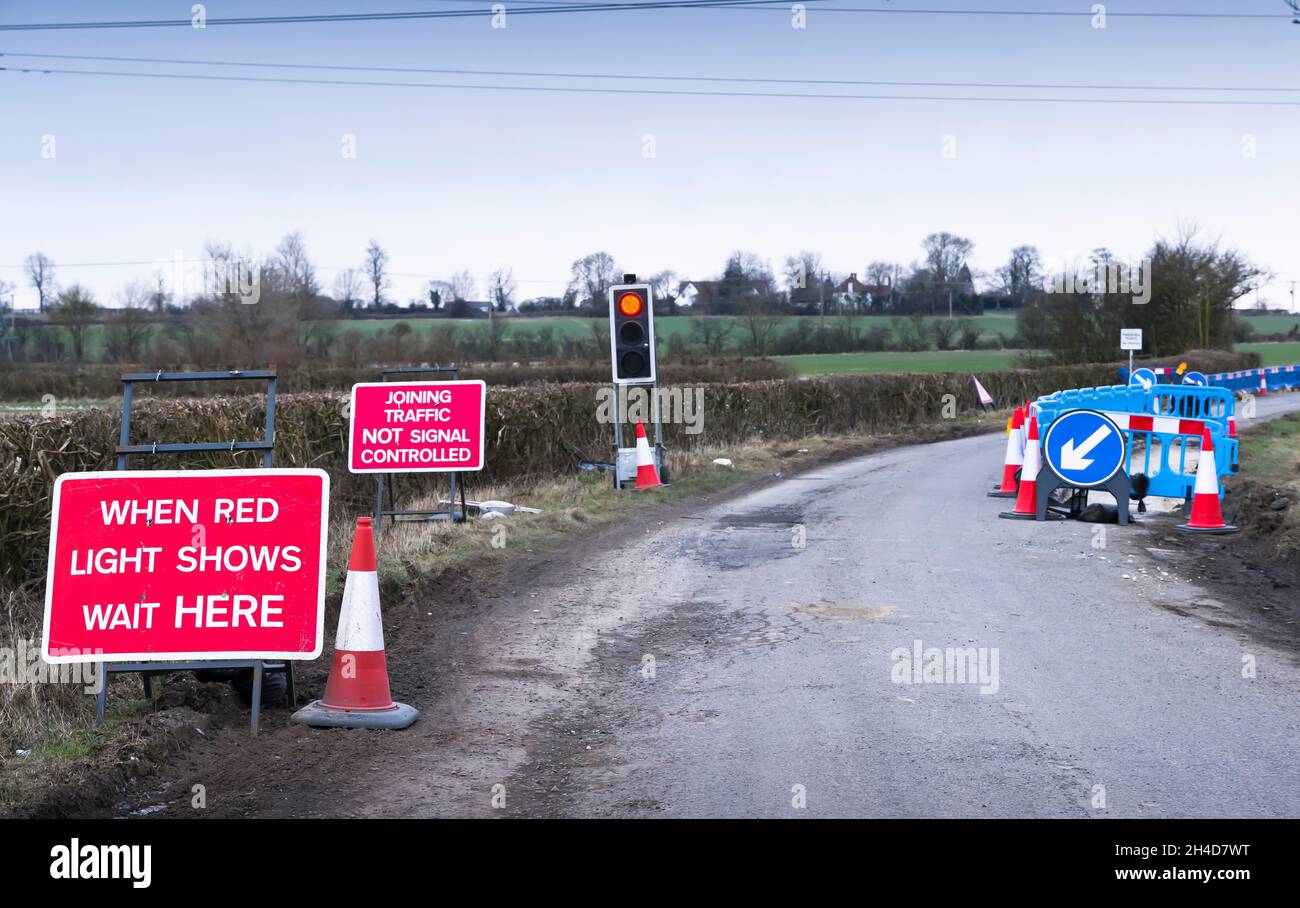 Traffic light on red at road works on a rural road, country lane, Buckinghamshire, UK Stock Photo