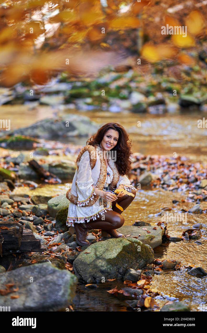 Portrait of a beautiful young woman by the river mid autumn Stock Photo ...
