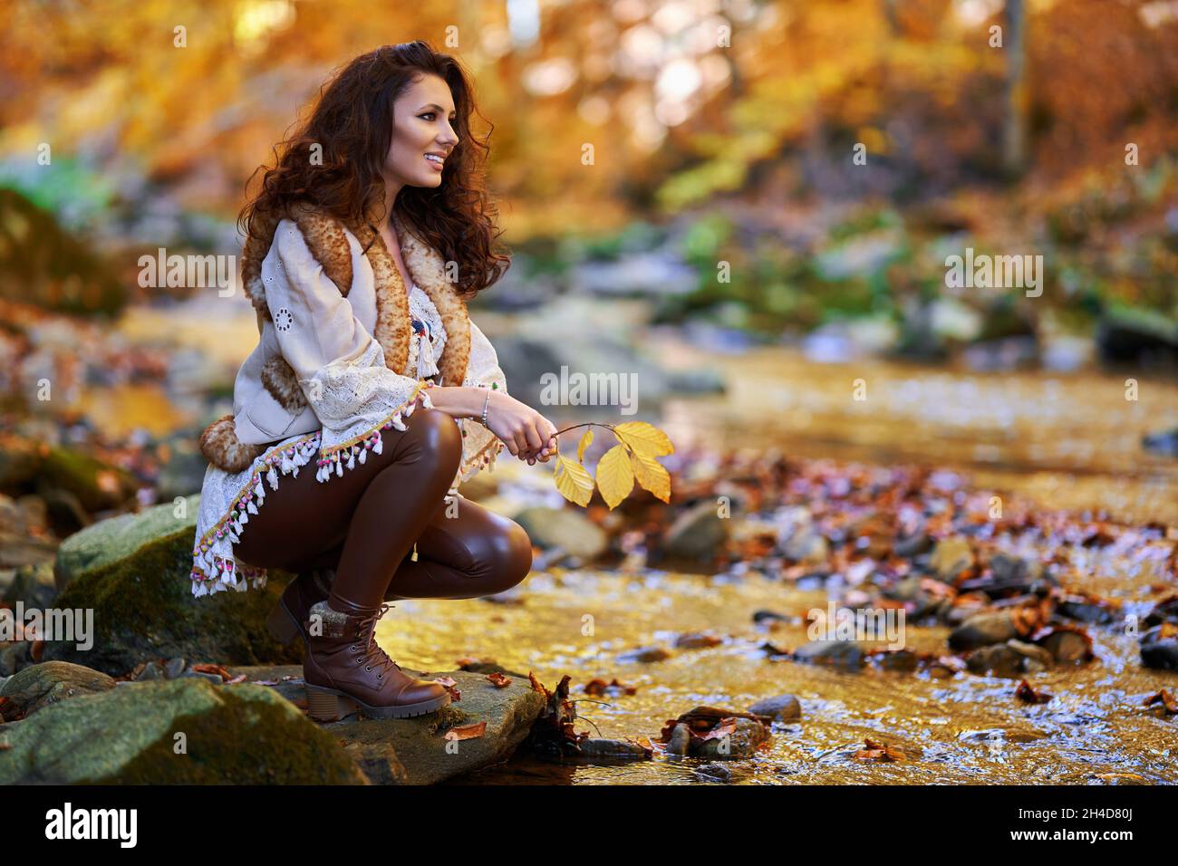 Portrait of a beautiful young woman by the river mid autumn Stock Photo ...