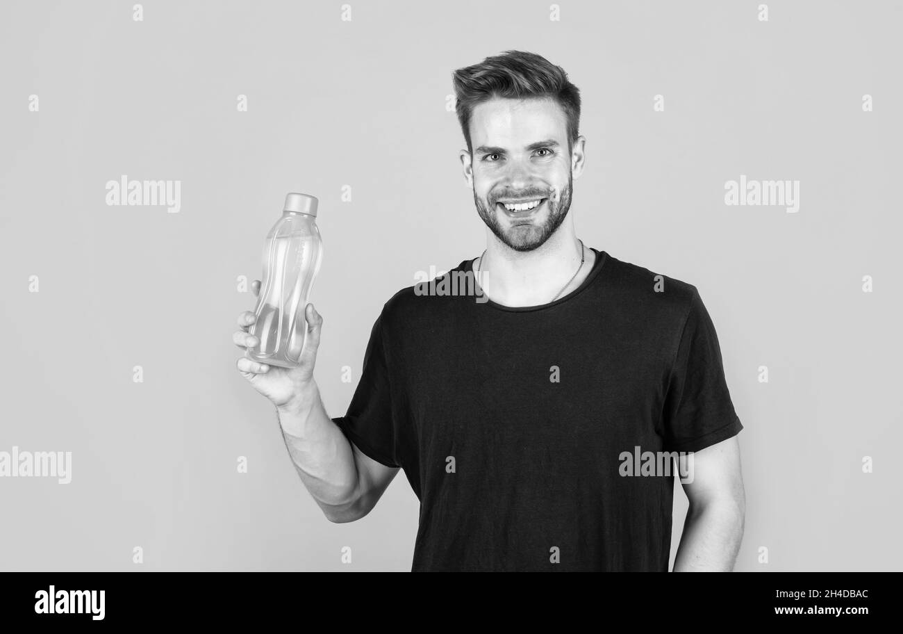 helps skin glow. Handsome Young Man With Fit Body Drinking Fresh Water