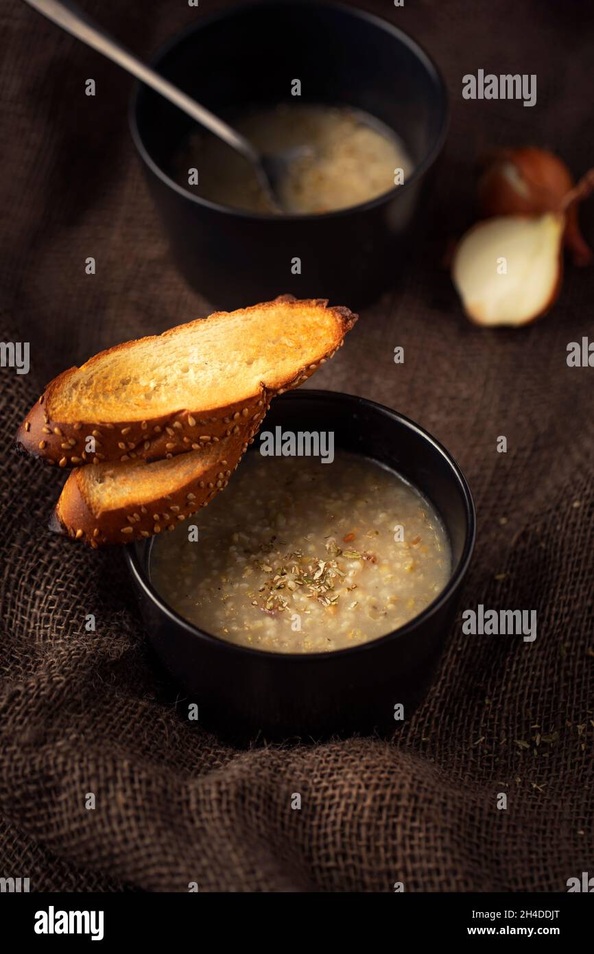Freekeh soup with toasted garlic bread Stock Photo