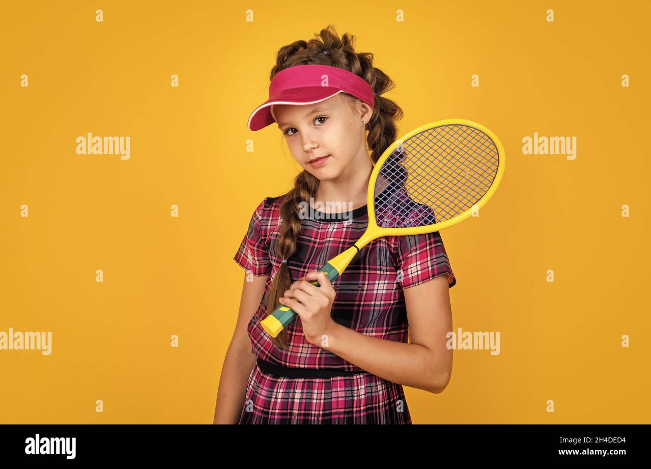 full of energy. happy childhood. kid in cap hold racket. child with ...