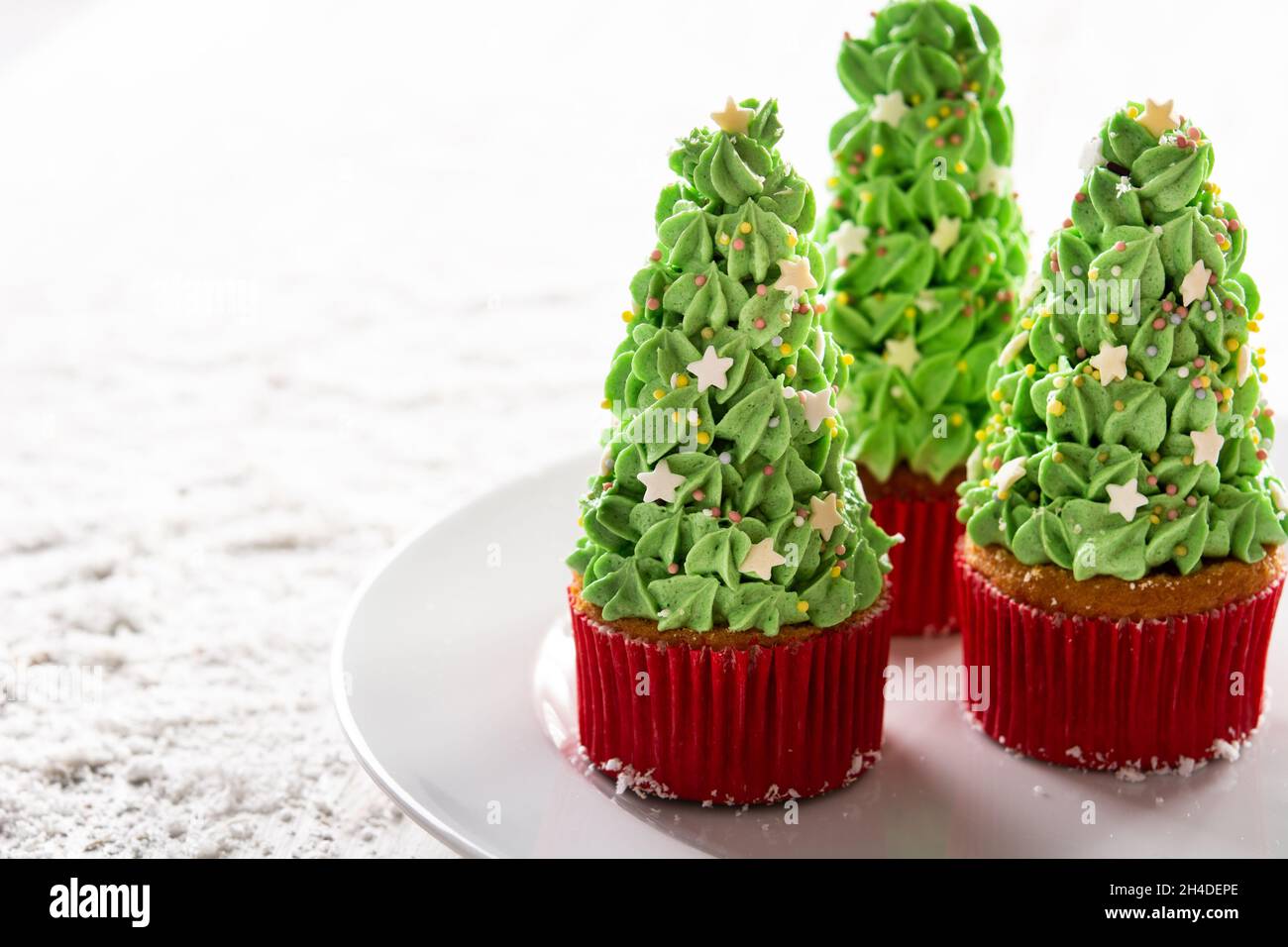 Christmas tree cupcakes on snow Stock Photo