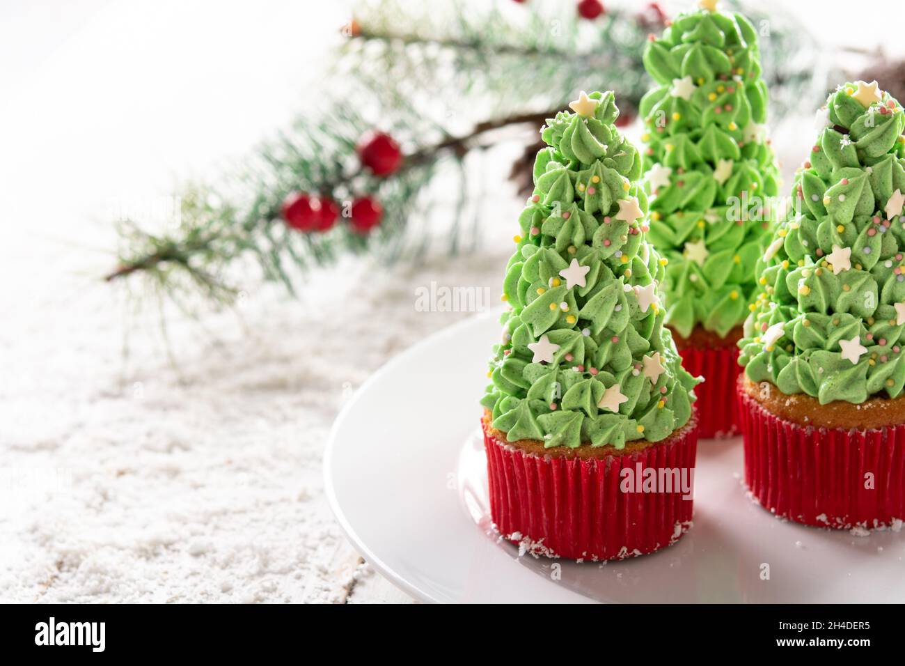 Christmas tree cupcakes isolated on white background Stock Photo