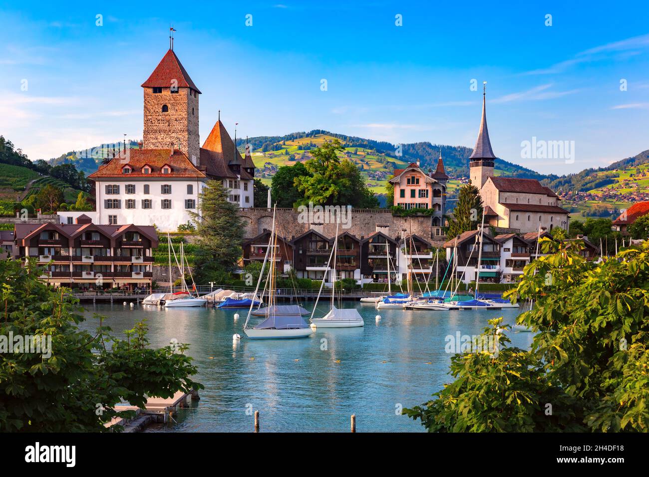 Spiez Church and Castle on the shore of Lake Thun in the Bernese Oberland region of the Swiss canton of Bern, Spiez, Switzerland. Stock Photo