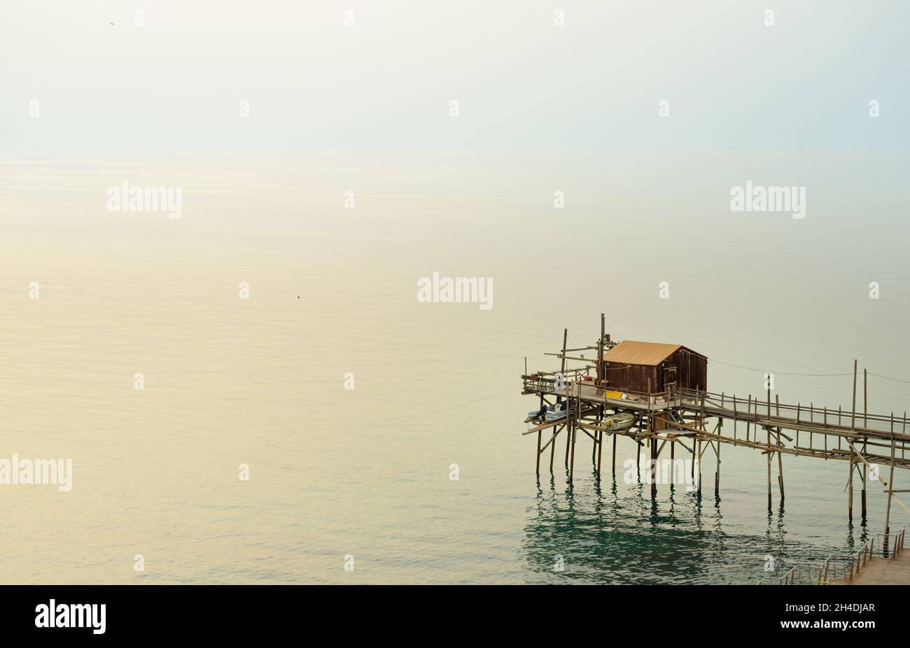 the trabucco is a fishing net winching mecanism mounted on stilts with a wood bridge, a heritage technology typical of Puglia coast, here in Termoli o Stock Photo