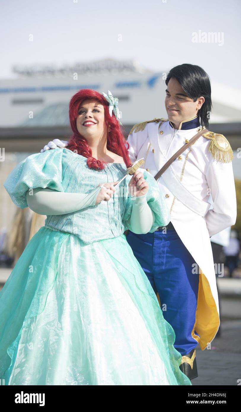 A couple of cosplayers dressed as Disney characters, princess Ariel and prince Eric at the MCM London Comic Con in London ExCeL on Sunday October 25th.  Stock Photo