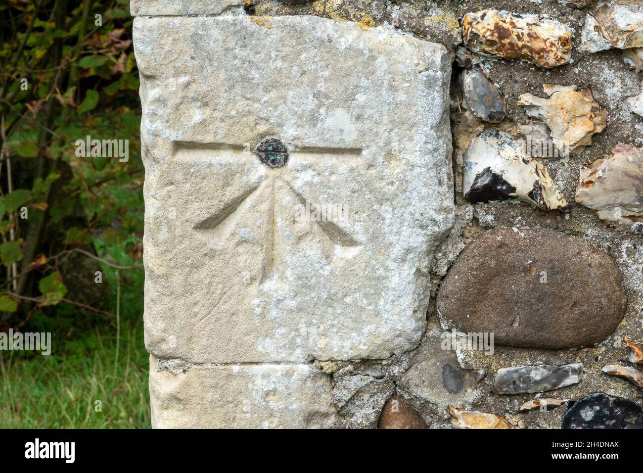 A surveyors benchmark on the corner stone of the Church of St Mary & St Peter Kelsale, Suffolk, UK Stock Photo