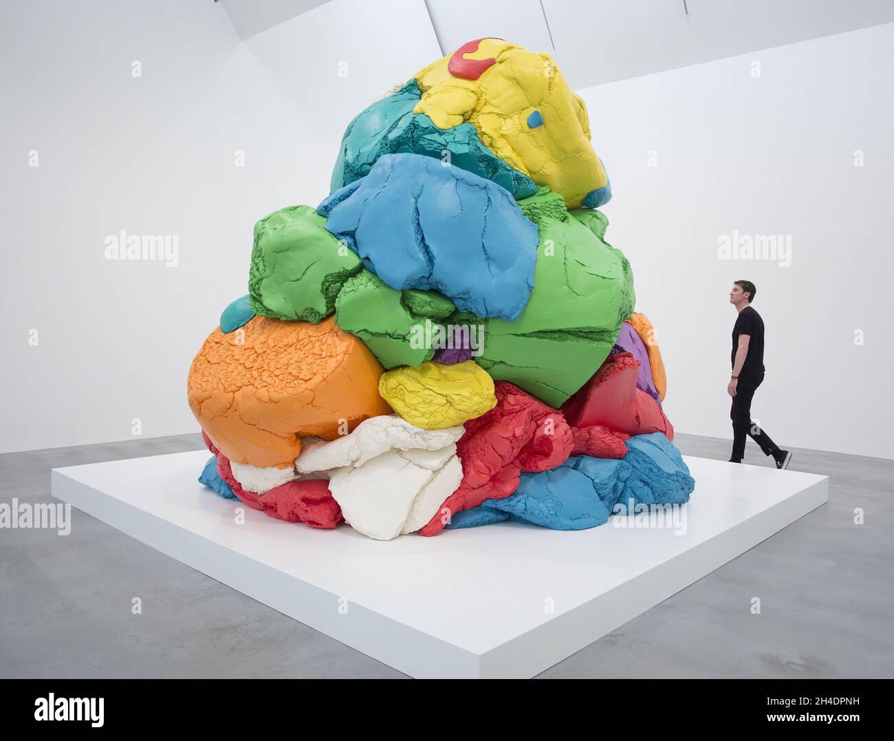 A gallery employee walks around Jeff Koons' artwork "PlayDoh