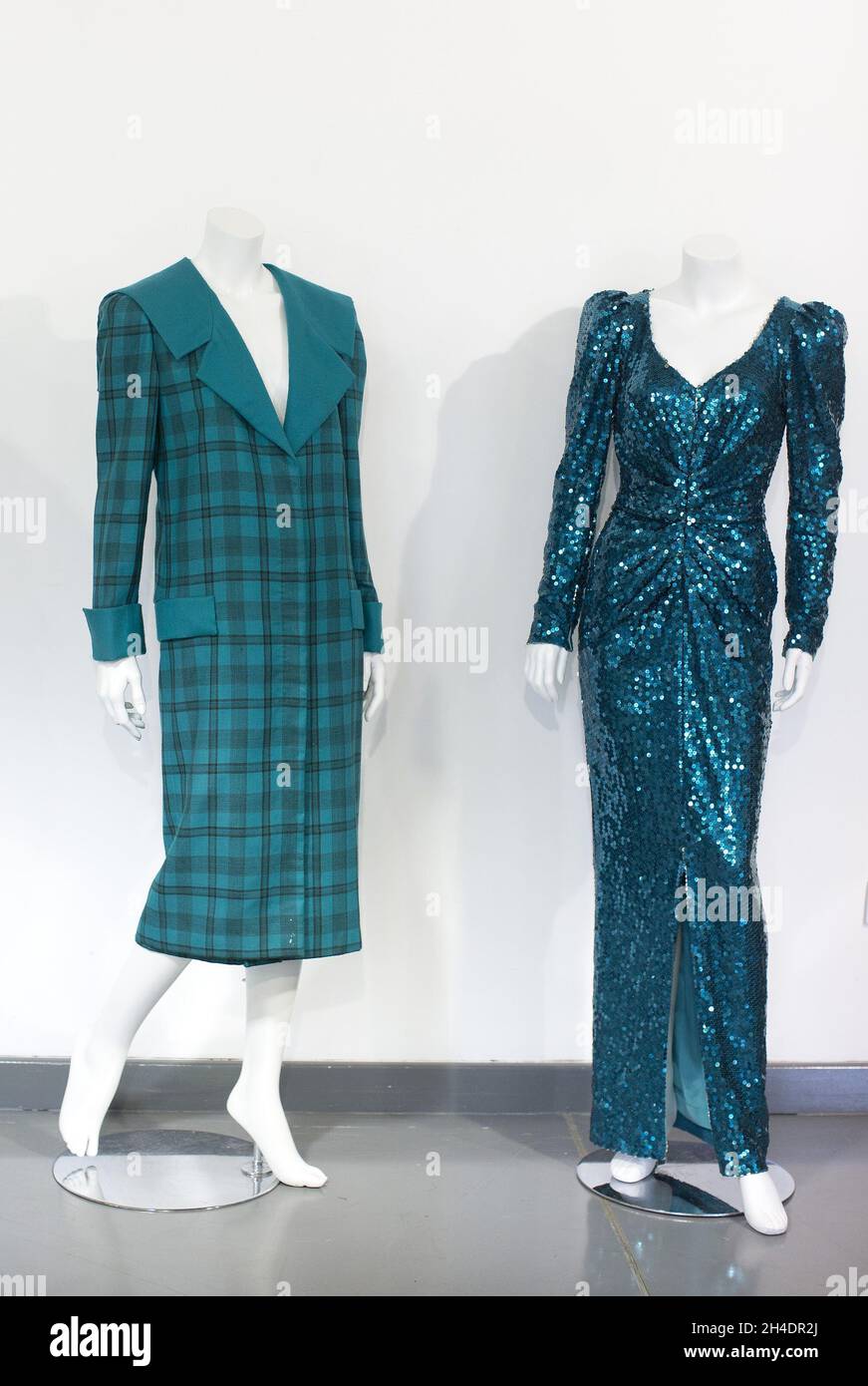Two dresses worn by Princess Diana, both in shades of teal-blue/green, part of the June 14th  Passion for fashion auction at Kerry Taylor Auctions in south London.  (Left) Lot 208, is a practical outfit, a large tartan check with wide padded shoulders with Diana's trademark sailor-collar, designed by Elizabeth and David Emanuel, estimate £10,000-15,000.  (Right) Lot 210, is a glamorous gown split to the knee by designer Catherine Walker, estimate £80,000-100,000. Stock Photo
