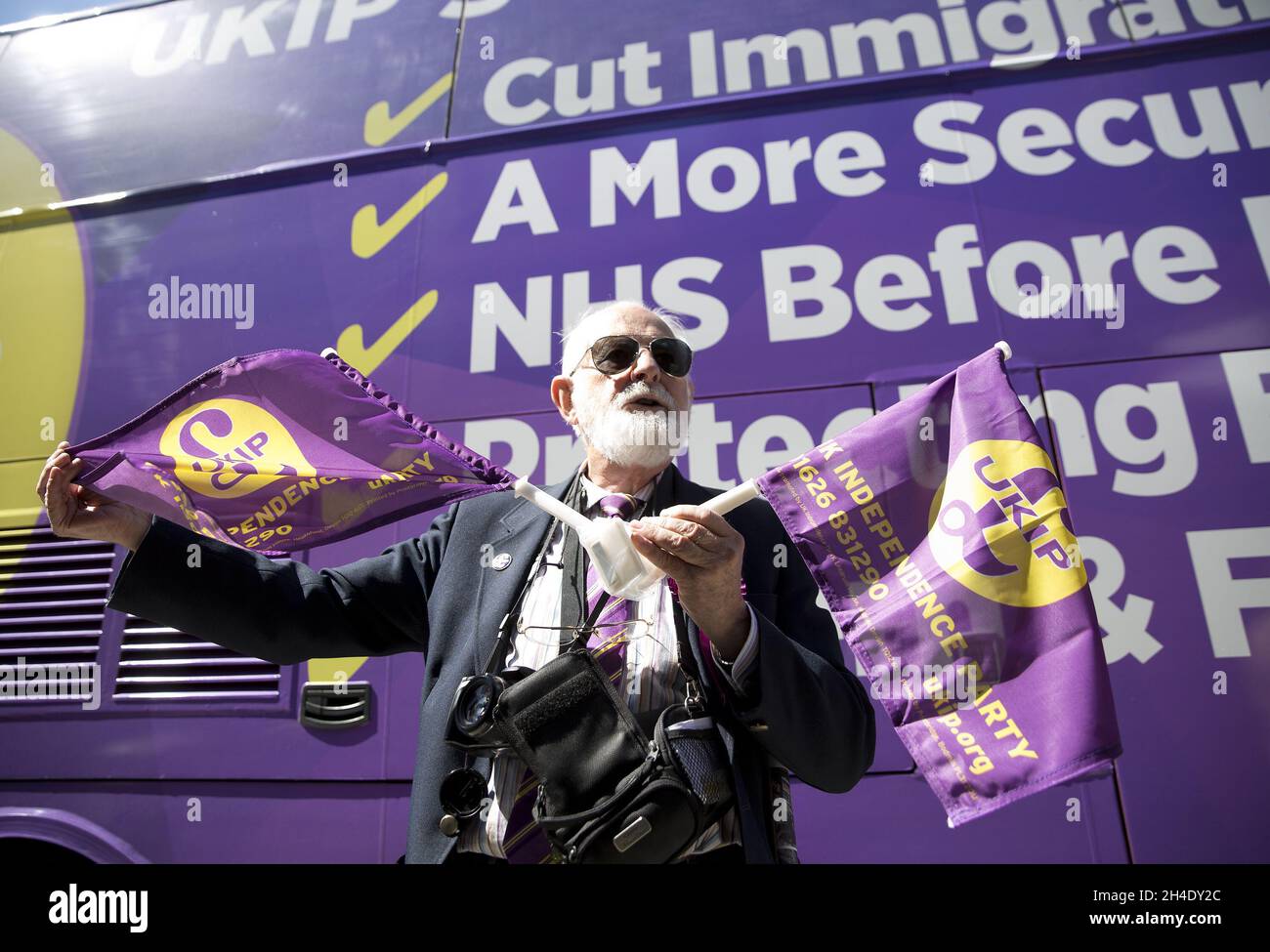 An UKIP supporter stands in front of the battle bus as party leader Paul Nuttall visits Clacton-on-Sea, Essex, during the campaign trail. Picture dated: Saturday May 20, 2017. Photo credit should read: Isabel Infantes/EMPICS Entertainment Stock Photo