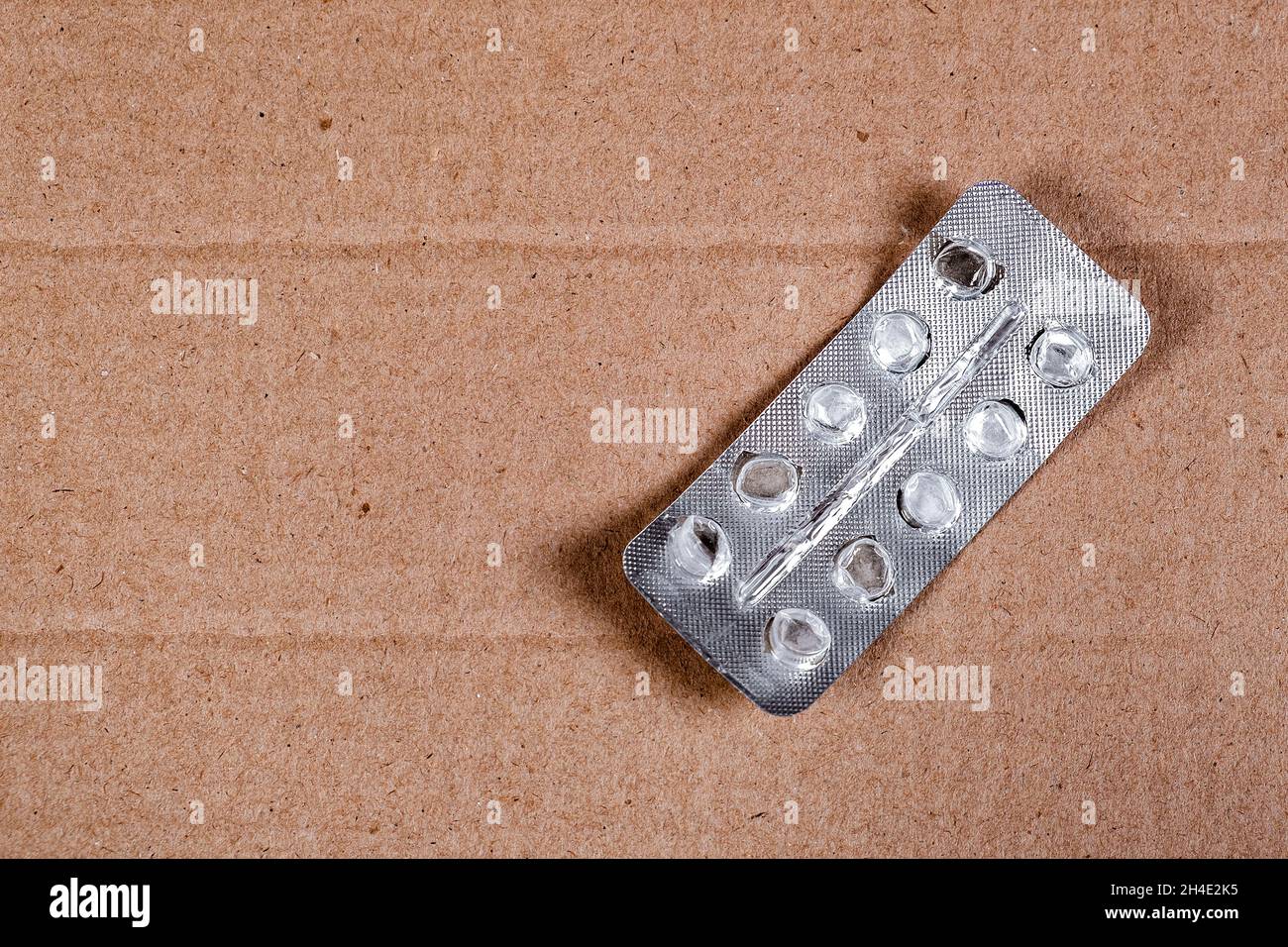 Empty Pack of the Pills on the Cardboard Background closeup Stock Photo