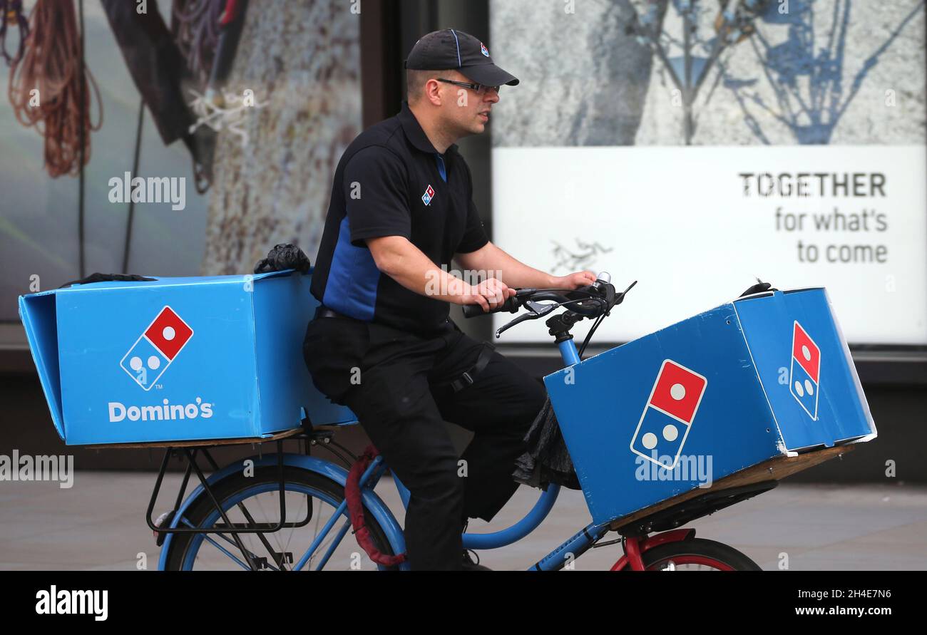 A Domino's Pizza delivery cyclist rides in central London, as the UK ...