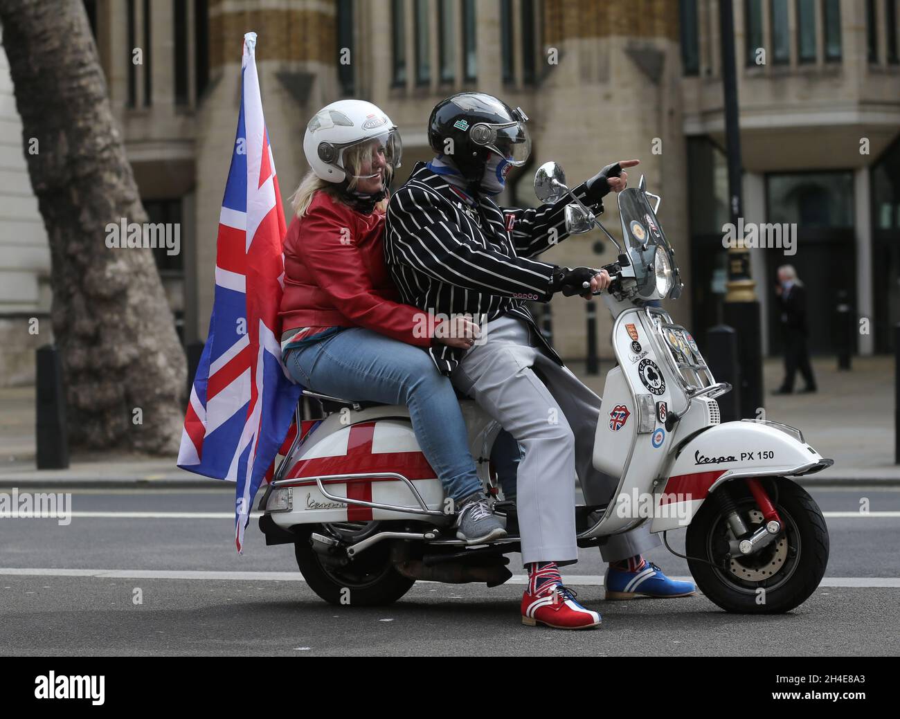 Frank Becket and Karen Miller from Fulham on their scooter at the Cenotaph, in Whitehall, London, to mark the 75th anniversary of VE Day. Picture date: Friday May 8, 2020.  Stock Photo